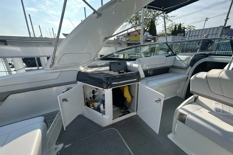 Yacht Photos Pics 2020 Formula 310SS boat interior with open storage compartment, showcasing seating and equipment.