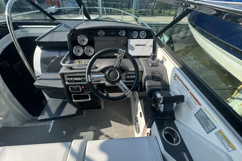  Yacht Photos Pics 2020 Formula 310SS boat cockpit with steering wheel and control panel.