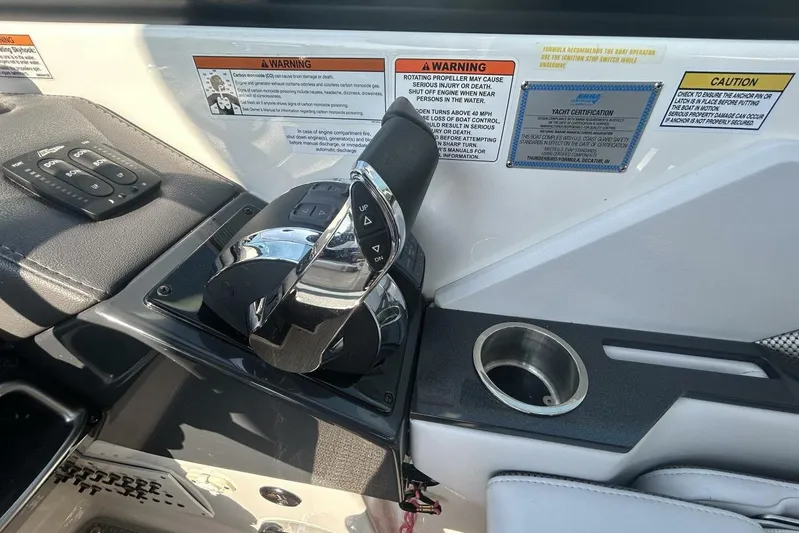  Yacht Photos Pics Control panel of a 2020 Formula 310SS boat with throttle and warning labels.