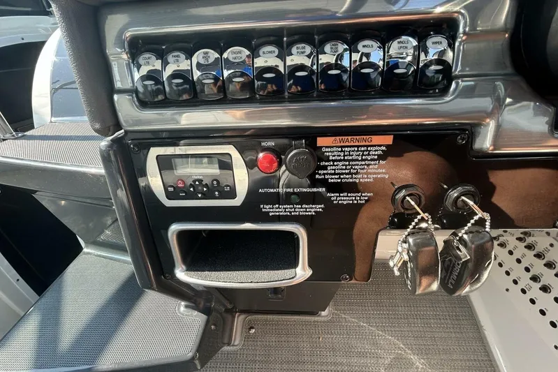  Yacht Photos Pics Control panel of a 2020 Formula 310SS boat with switches and ignition keys.