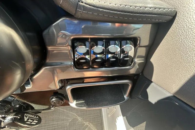  Yacht Photos Pics Control panel of a 2020 Formula 310SS boat with chrome switches and leather accents.