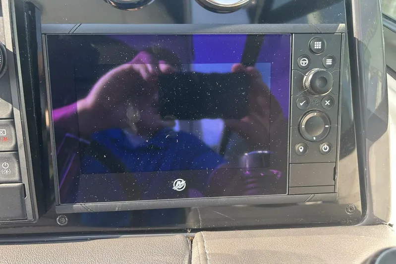  Yacht Photos Pics Control panel of a 2020 Formula 310SS boat with touchscreen and buttons.