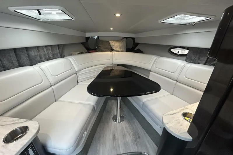  Yacht Photos Pics Luxurious interior of a 2020 Formula 310SS boat with white seating and sleek black table.