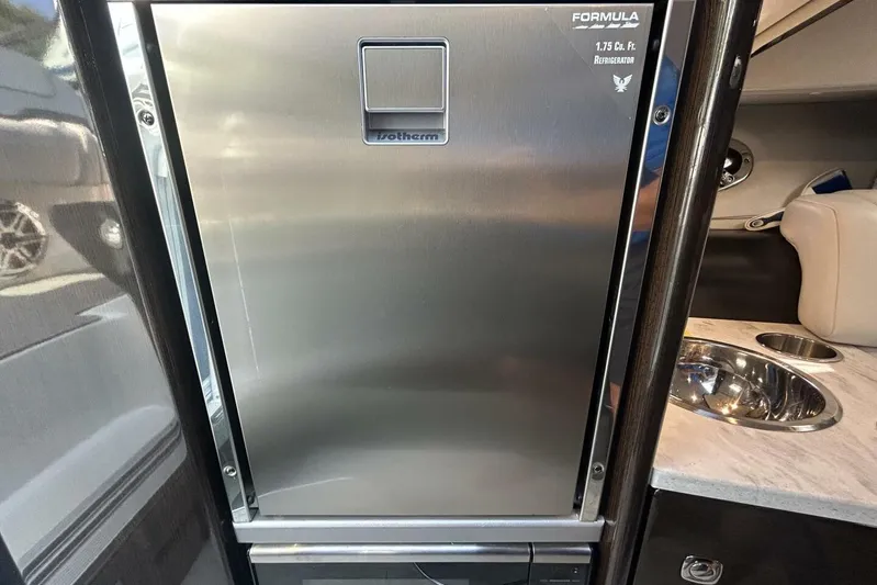  Yacht Photos Pics 2020 Formula 310SS boat interior with stainless steel refrigerator and sink.