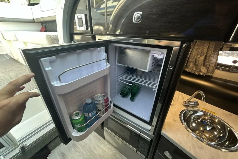  Yacht Photos Pics Compact fridge in 2020 Formula 310SS boat galley, stocked with drinks.