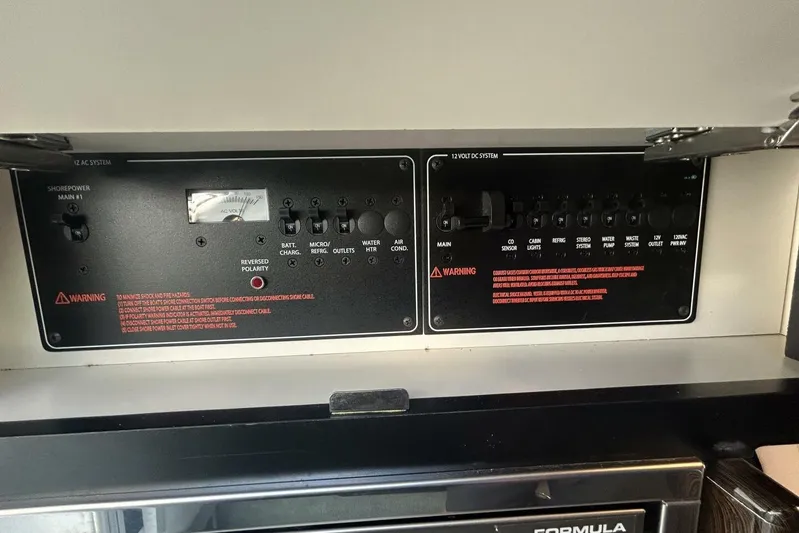  Yacht Photos Pics Control panel of a 2020 Formula 310SS boat, featuring AC and DC systems.