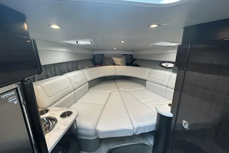  Yacht Photos Pics Luxurious interior of 2020 Formula 310SS boat with white leather seating and modern amenities.