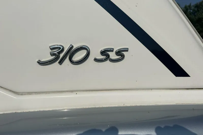  Yacht Photos Pics 2020 Formula 310SS boat emblem on white surface with blue stripe.