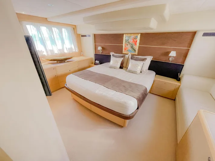  Yacht Photos Pics Luxurious bedroom interior of 2008 Princess 62 Flybridge yacht with elegant decor and natural light.