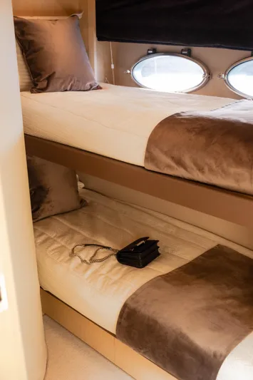  Yacht Photos Pics Bunk beds in 2008 Princess 62 Flybridge yacht cabin with porthole windows.