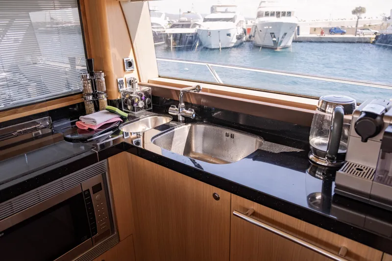  Yacht Photos Pics Luxurious kitchen interior of 2008 Princess 62 Flybridge yacht with marina view.