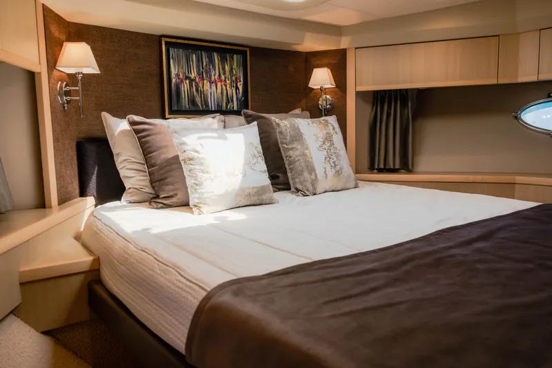  Yacht Photos Pics Luxurious bedroom interior on 2008 Princess 62 Flybridge yacht with elegant decor and soft lighting.