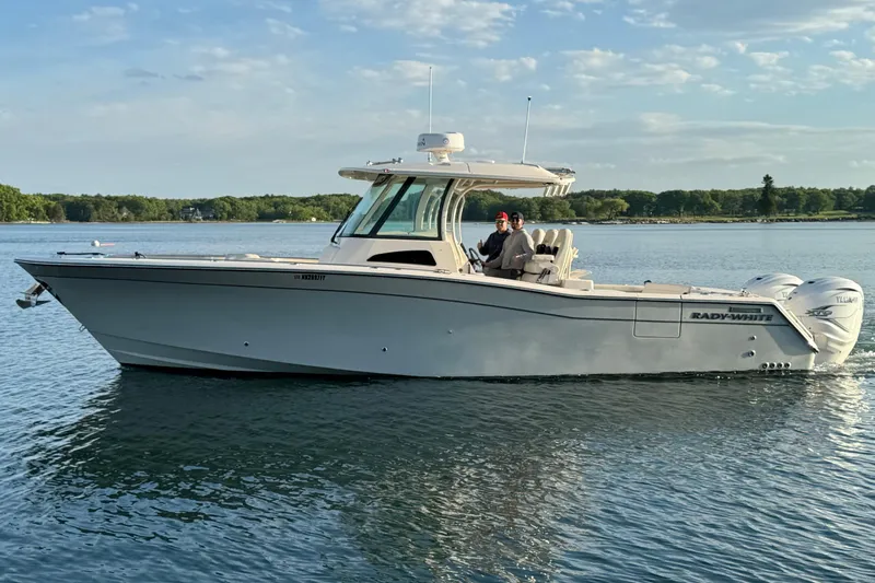  Yacht Photos Pics 2020 Grady-White Canyon 336 boat on calm water, featuring dual outboard engines.