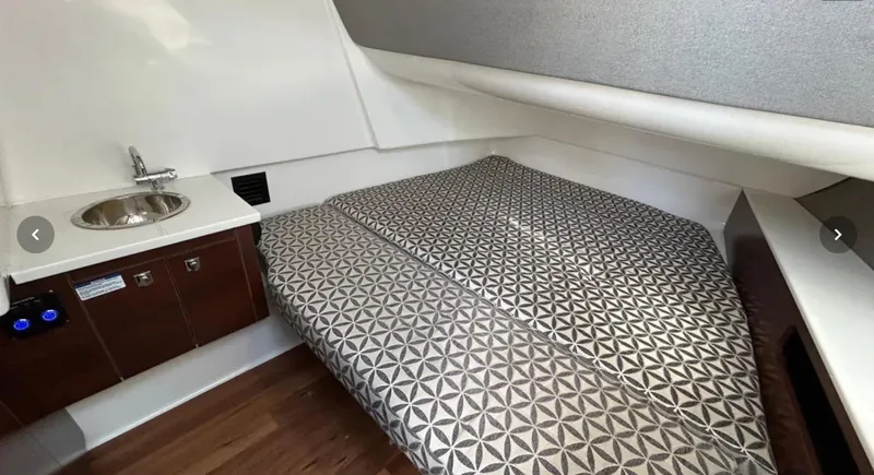  Yacht Photos Pics 2024 Chaparral 300 OSX cabin interior with bed and sink.