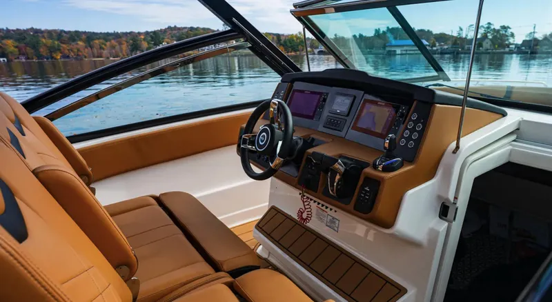  Yacht Photos Pics 2024 Chaparral 300 OSX boat interior with modern dashboard and tan seating.
