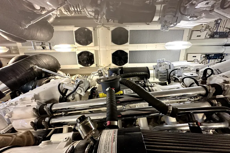 Reel Inn Yacht Photos Pics Engine room of a 2003 Viking 61 Convertible yacht, showcasing mechanical components.