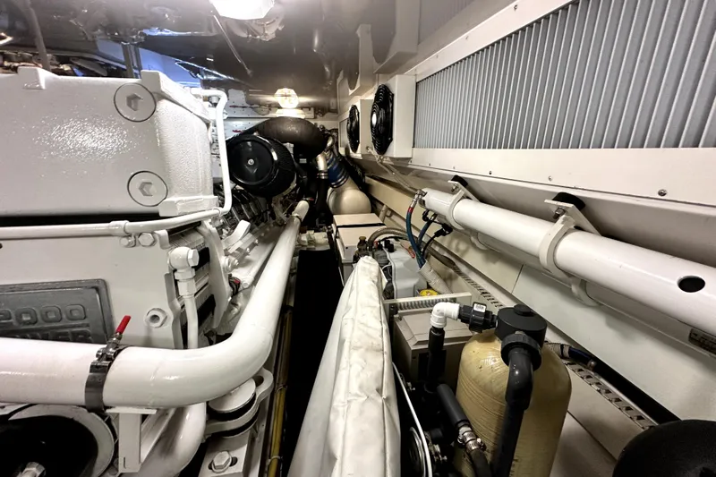 Reel Inn Yacht Photos Pics Engine room of 2003 Viking 61 Convertible yacht, showcasing mechanical components and piping.