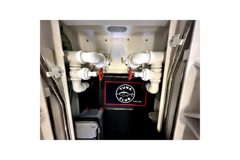 Reel Inn Yacht Photos Pics Engine room of 2003 Viking 61 Convertible yacht with pipes and Tuna Club mat.