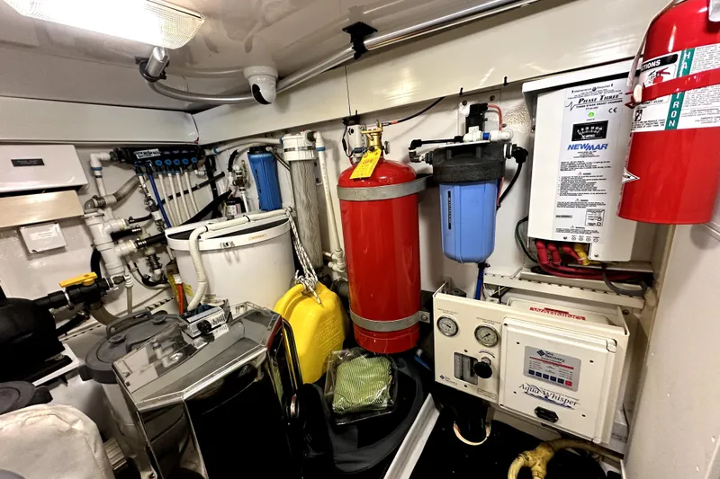 Reel Inn Yacht Photos Pics Engine room of 2003 Viking 61 Convertible yacht with equipment and fire extinguisher.