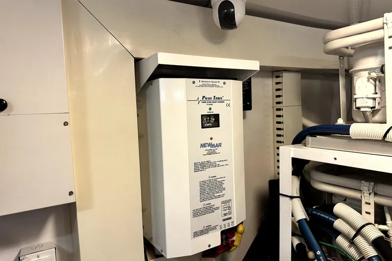 Reel Inn Yacht Photos Pics Electrical system in a 2003 Viking 61 Convertible yacht engine room, featuring a Newmar Phase Three charger.