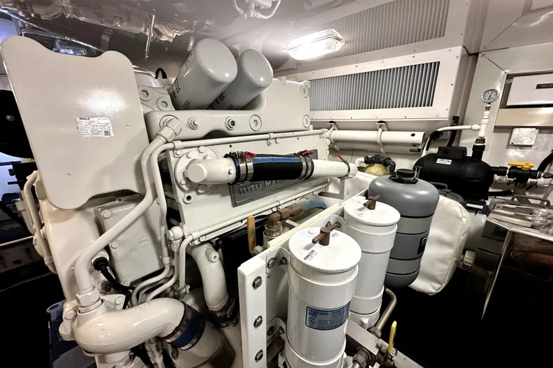 Reel Inn Yacht Photos Pics Engine room of a 2003 Viking 61 Convertible yacht, showcasing mechanical components and filters.