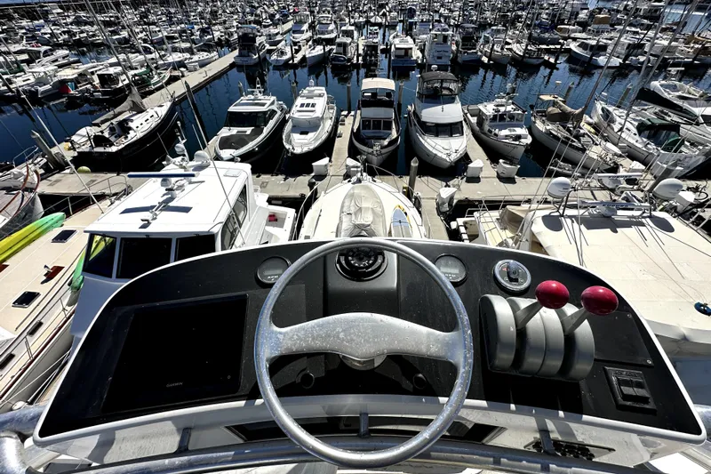 Reel Inn Yacht Photos Pics View from 2003 Viking 61 Convertible yacht helm overlooking marina with numerous boats docked.