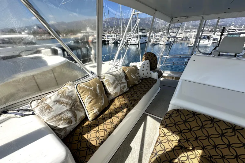 Reel Inn Yacht Photos Pics Luxurious interior of 2003 Viking 61 Convertible yacht with patterned cushions and marina view.
