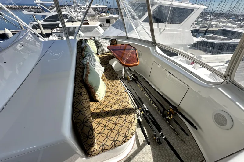 Reel Inn Yacht Photos Pics Luxurious 2003 Viking 61 Convertible yacht interior with fishing rods and elegant seating.