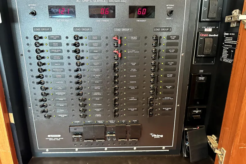Reel Inn Yacht Photos Pics Electrical control panel of a 2003 Viking 61 Convertible yacht, featuring various switches and meters.