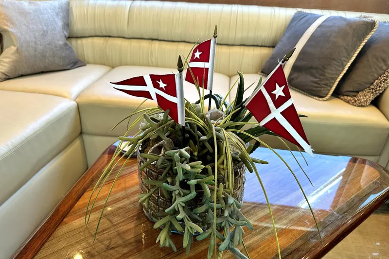 Reel Inn Yacht Photos Pics Decorative plant with Santa Barbara Yacht Club flags on a 2003 Viking 61 Convertible yacht's wooden table.