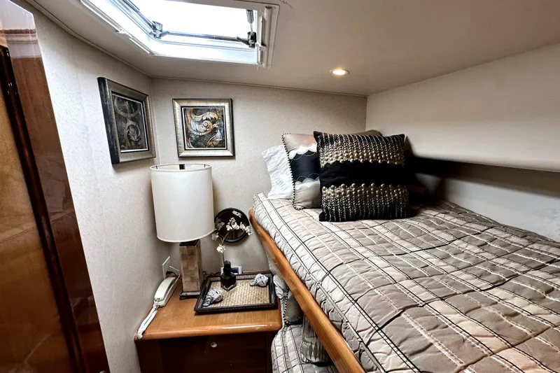 Reel Inn Yacht Photos Pics Cozy cabin interior of 2003 Viking 61 Convertible yacht with bed and decor.