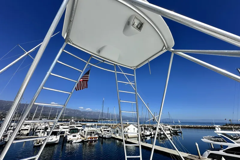 Reel Inn Yacht Photos Pics View from a 2003 Viking 61 Convertible yacht, overlooking a marina with clear blue skies.