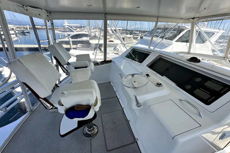 Reel Inn Yacht Photos Pics Helm of 2003 Viking 61 Convertible yacht with modern controls and seating.