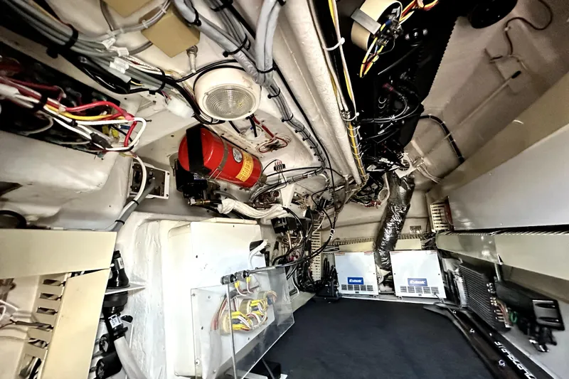 Reel Inn Yacht Photos Pics Under helm room of 2003 Viking 61 Convertible yacht, showcasing wiring and equipment.