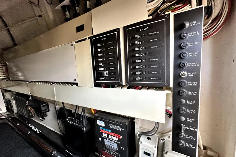 Reel Inn Yacht Photos Pics Electrical panel of a 2003 Viking 61 Convertible yacht, showcasing various switches and wiring.