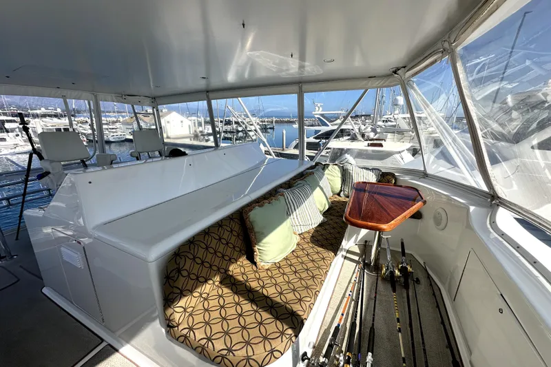 Reel Inn Yacht Photos Pics Luxurious 2003 Viking 61 Convertible yacht interior with seating, cushions, and fishing rods.