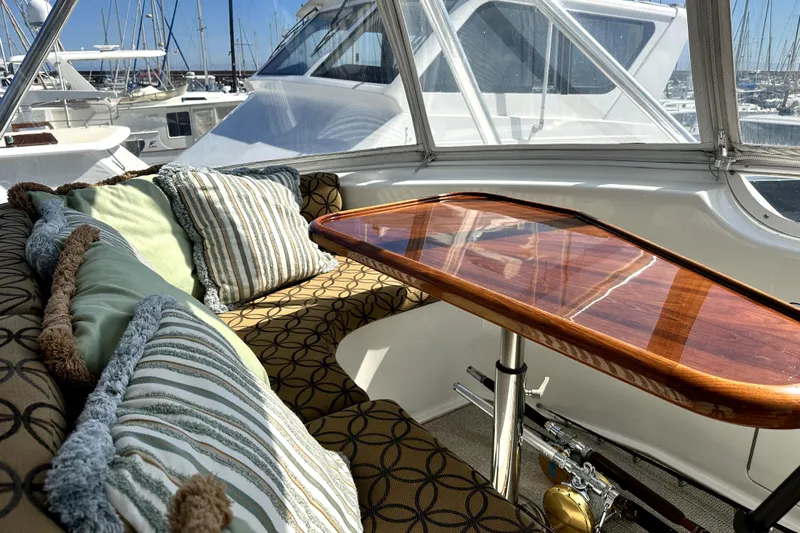 Reel Inn Yacht Photos Pics Luxurious interior of 2003 Viking 61 Convertible yacht with plush seating and polished wood table.