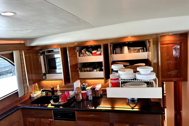 Reel Inn Yacht Photos Pics Luxurious kitchen interior of 2003 Viking 61 Convertible yacht with modern amenities.