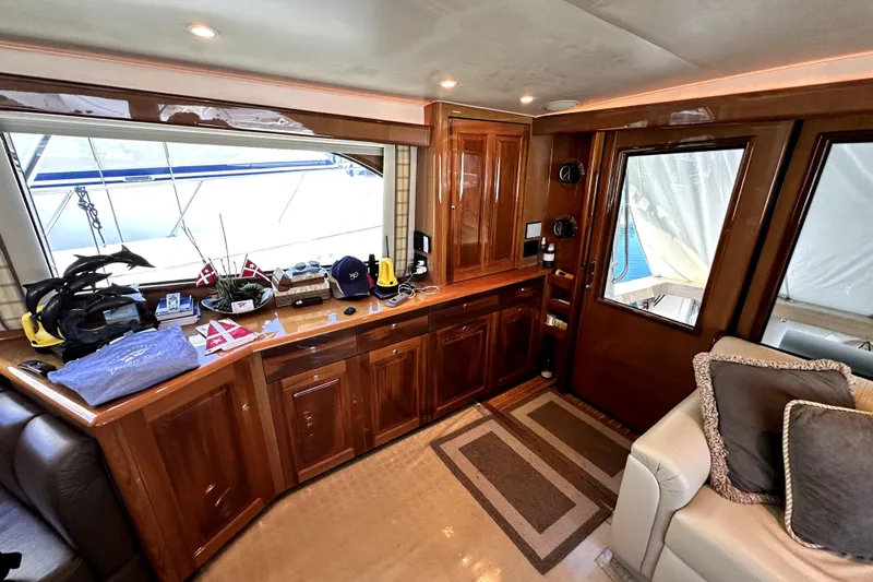 Reel Inn Yacht Photos Pics Luxurious interior of 2003 Viking 61 Convertible yacht with wooden cabinetry and plush seating.