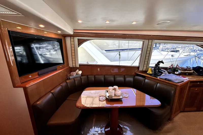 Reel Inn Yacht Photos Pics Luxurious interior of 2003 Viking 61 Convertible yacht with leather seating and large windows.