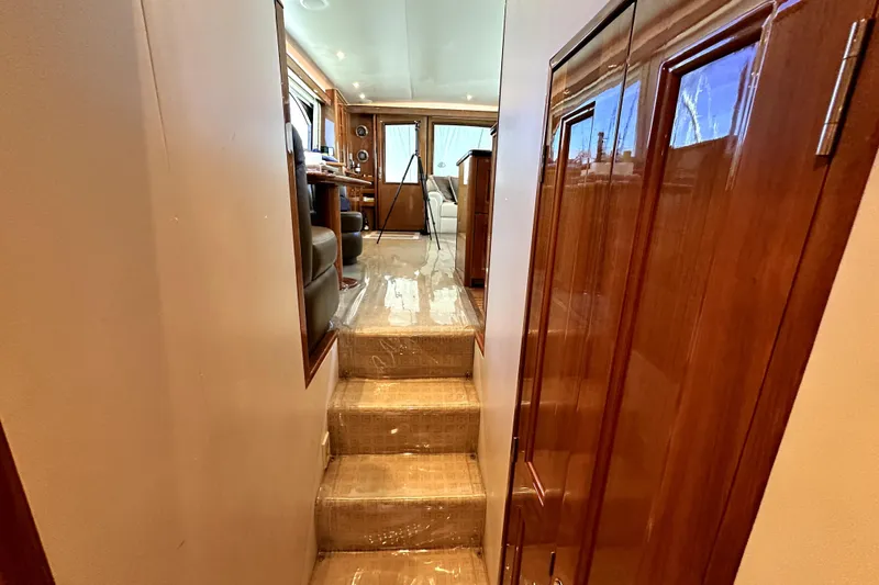 Reel Inn Yacht Photos Pics Interior view of 2003 Viking 61 Convertible yacht with wooden finishes and carpeted stairs.