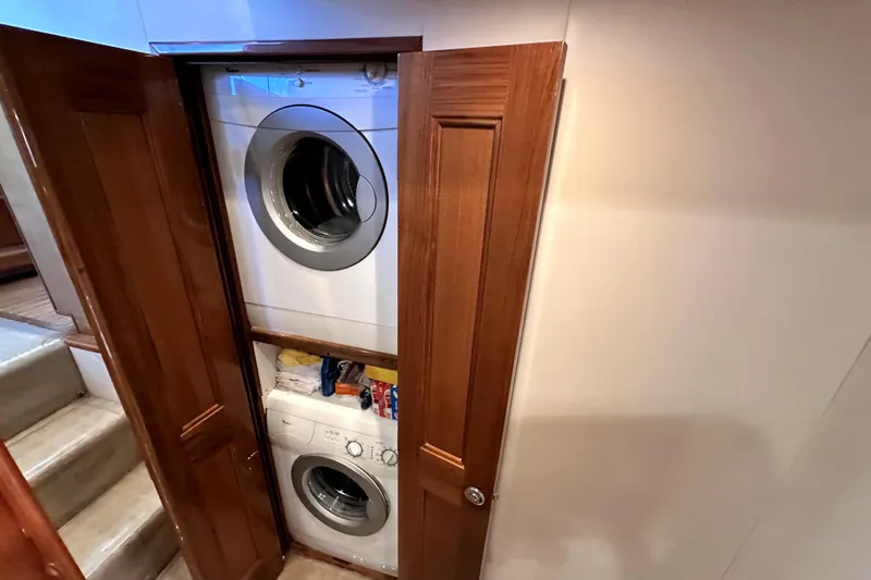 Reel Inn Yacht Photos Pics Stacked washer and dryer in 2003 Viking 61 Convertible yacht's wooden closet.