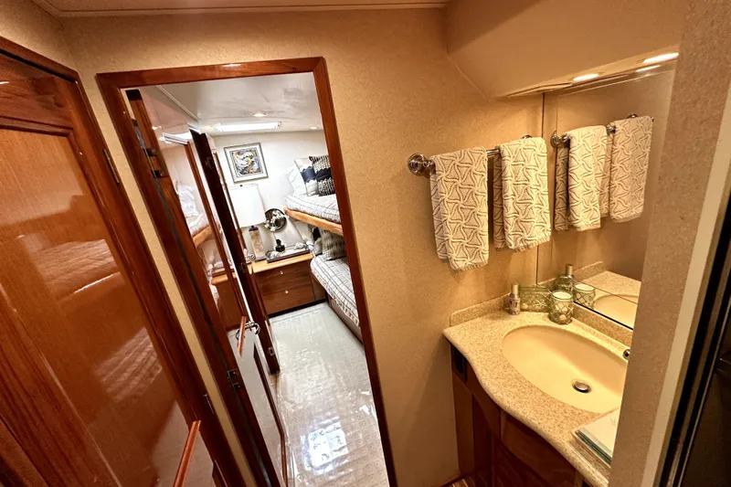 Reel Inn Yacht Photos Pics Interior of 2003 Viking 61 Convertible yacht with bathroom and cozy bedroom.