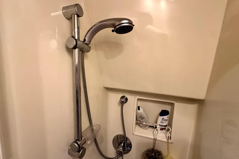 Reel Inn Yacht Photos Pics Shower area in 2003 Viking 61 Convertible yacht with chrome fixtures and toiletries.