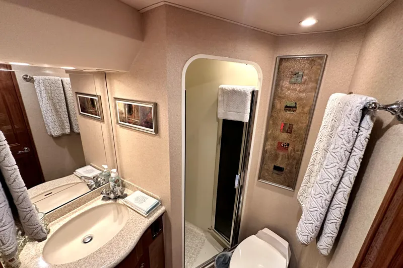 Reel Inn Yacht Photos Pics Luxurious bathroom in 2003 Viking 61 Convertible yacht with elegant fixtures and decor.