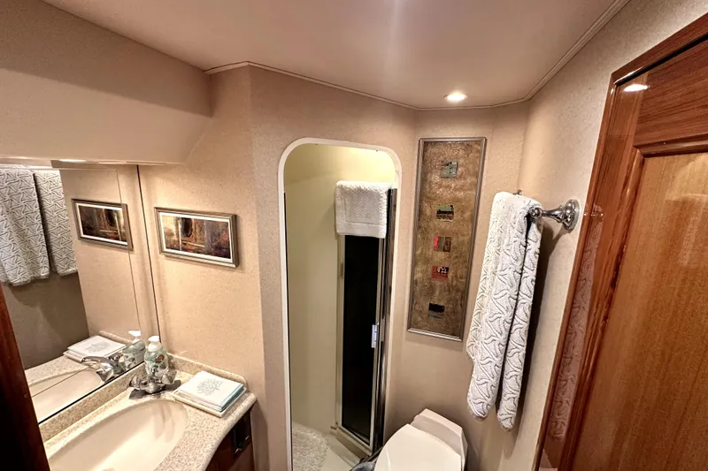 Reel Inn Yacht Photos Pics Luxurious bathroom interior of 2003 Viking 61 Convertible yacht with elegant fixtures.