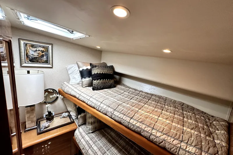 Reel Inn Yacht Photos Pics Cozy cabin interior of 2003 Viking 61 Convertible yacht with elegant bedding and decor.