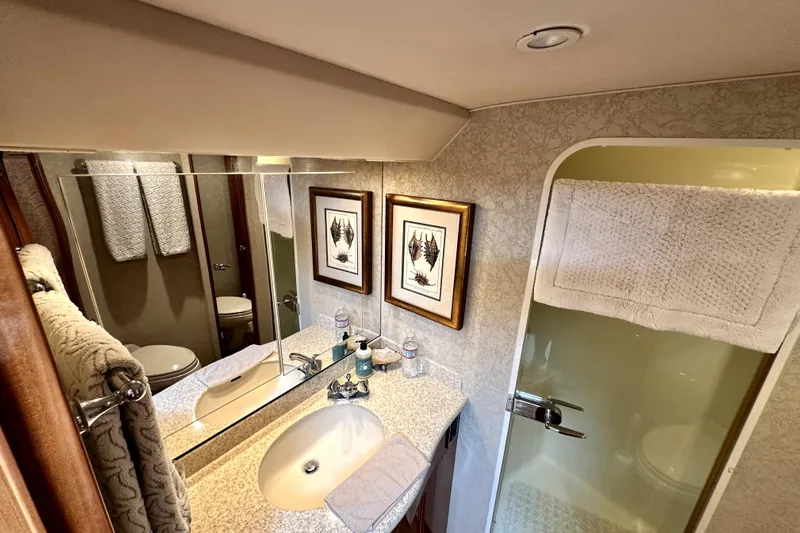 Reel Inn Yacht Photos Pics Luxurious bathroom in 2003 Viking 61 Convertible yacht with elegant decor and modern amenities.