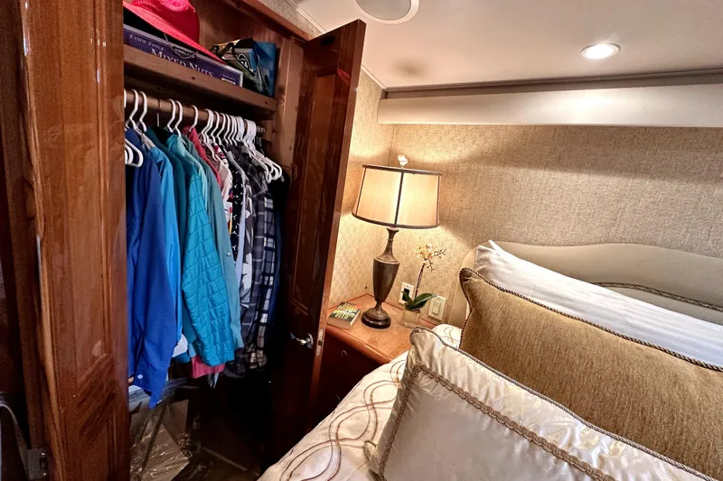 Reel Inn Yacht Photos Pics Cozy bedroom in 2003 Viking 61 Convertible yacht with closet and lamp.