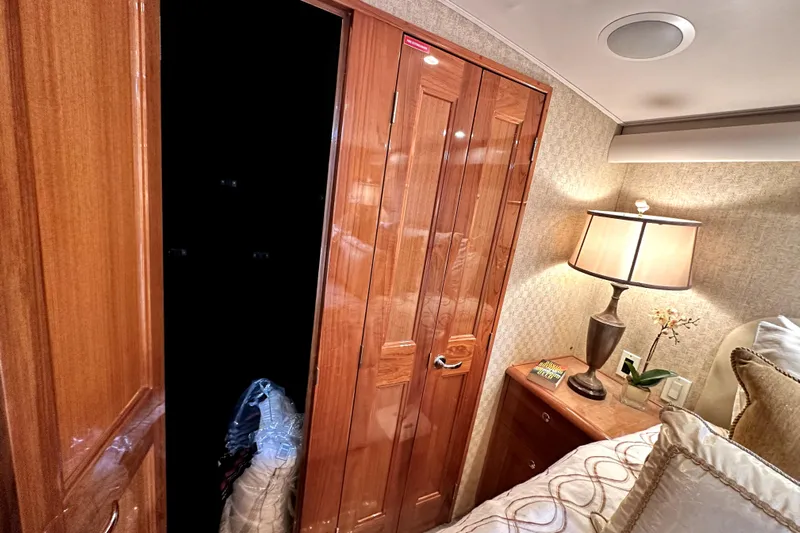 Reel Inn Yacht Photos Pics Interior of 2003 Viking 61 Convertible yacht with wooden closet and bedside lamp.
